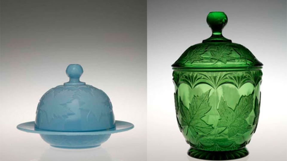 Two glass containers, one blue with a dome-shaped lid and base, the other green with a tall, ornate lid and textured pattern.