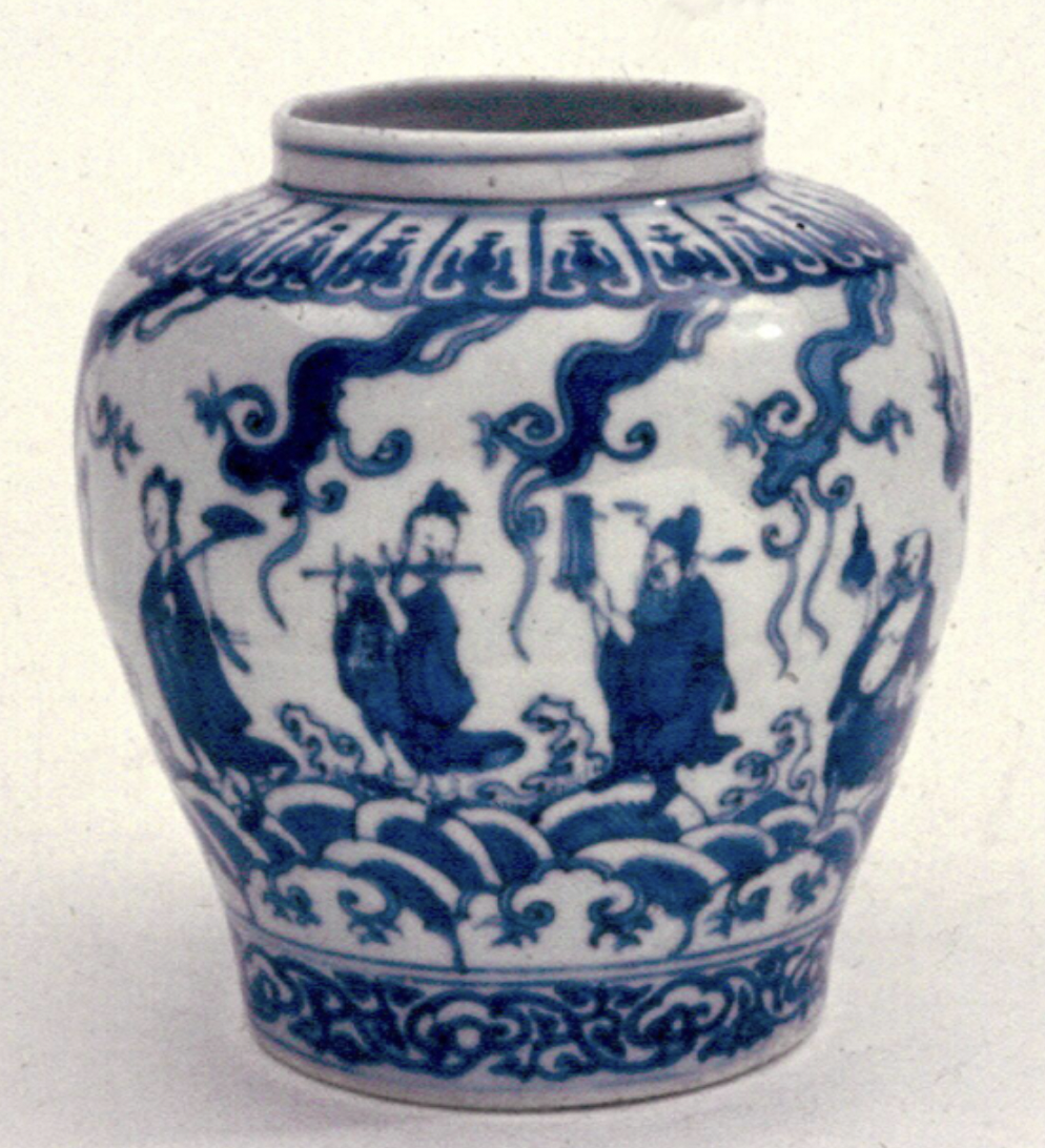 Blue-and-white ceramic jar with a wide mouth and rounded body. The surface is decorated with cobalt-blue painted scenes of several robed figures standing among stylized waves and swirling cloud-like shapes. Decorative bands of repeating patterns encircle the rim and base. The jar is photographed against a plain, light background, highlighting the contrast between the white glaze and the deep blue designs.