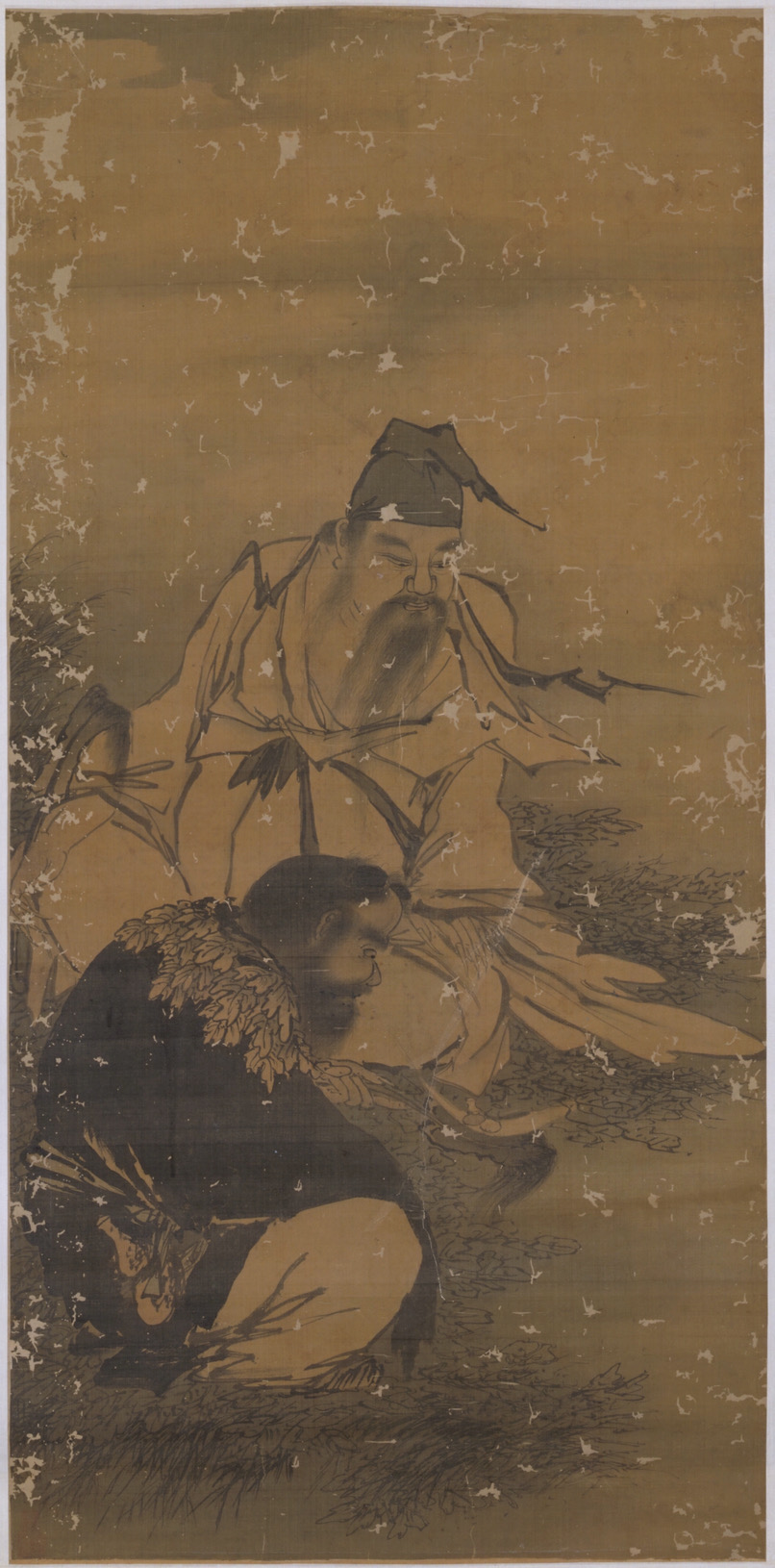 Vertical ink-and-wash painting on a tan, aged scroll. Two human figures in flowing robes are shown outdoors among grasses and rocks; one figure stands or leans forward holding long, leafy branches, while another figure crouches below with a hunched posture. The style is monochrome linework with light ink washes, visible wear, and scattered patches of abrasion across the surface.