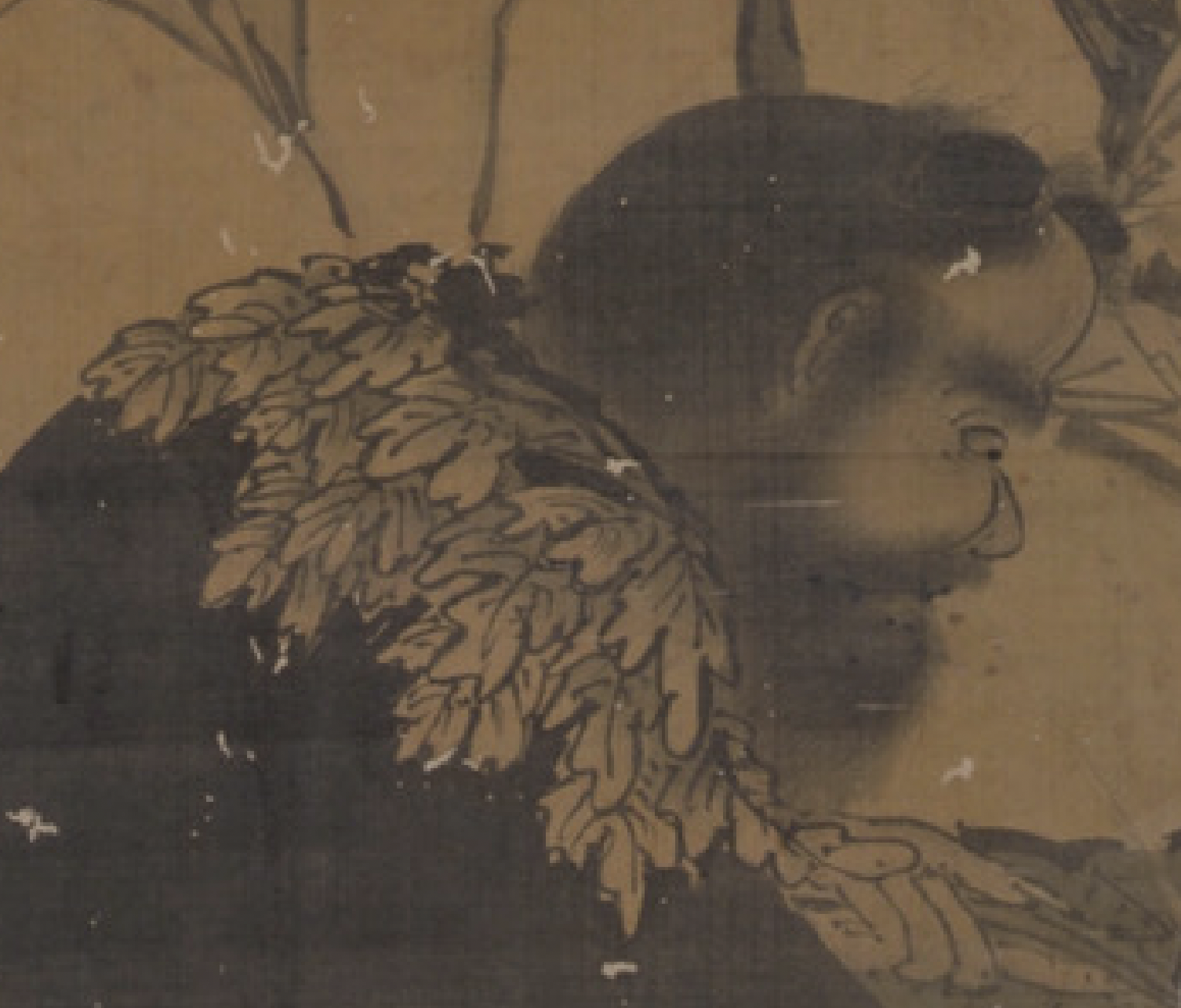 Vertical ink-and-wash painting on a tan, aged scroll. Two human figures in flowing robes are shown outdoors among grasses and rocks; one figure stands or leans forward holding long, leafy branches, while another figure crouches below with a hunched posture. The style is monochrome linework with light ink washes, visible wear, and scattered patches of abrasion across the surface.