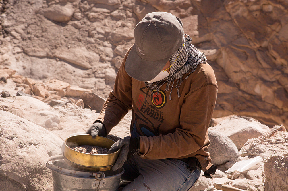 andes_early_civilization, Billy Oscco Llanos sifts through excavated material with a fine mesh to recover the small artifacts.