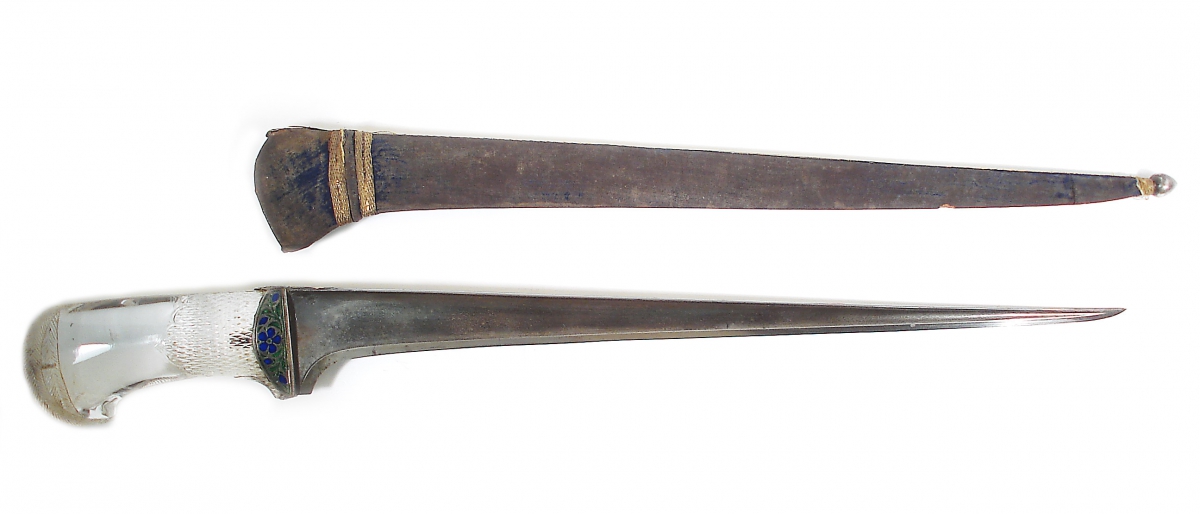 Two narrow, elongated artifacts, one brownish and the other metallic with a curved end.