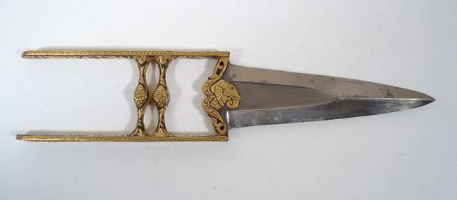 Metal weapon with a wide, double-edged blade and an open rectangular hilt with symmetrical cutout designs.