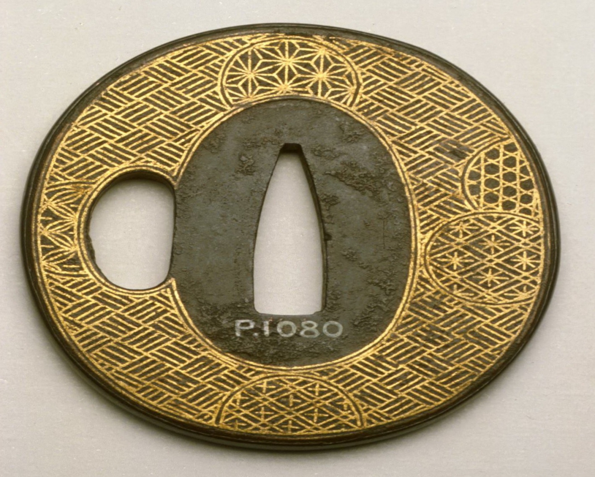 P.1080 on a gold and silver oval Japanese sword guard with engraved circular patterns