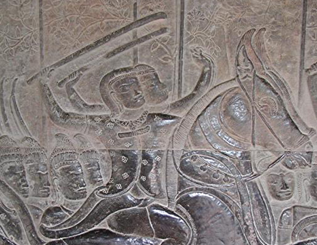 Carved stone relief depicting two figures, one wielding a weapon above their head.