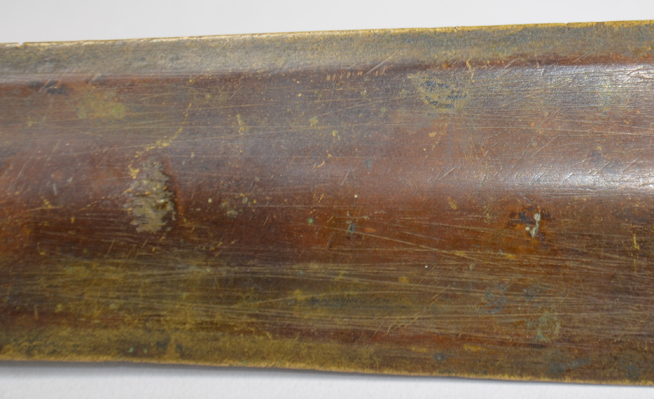 Wooden surface with faint carved markings or scratches.