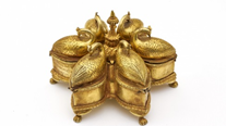 Ornate golden container shaped like five connected birds with detailed feather and feathered tail designs.