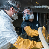 ROM research technicians work with two ROM Biodiversity volunteers to drain the last of the formalin from the heart tank.
