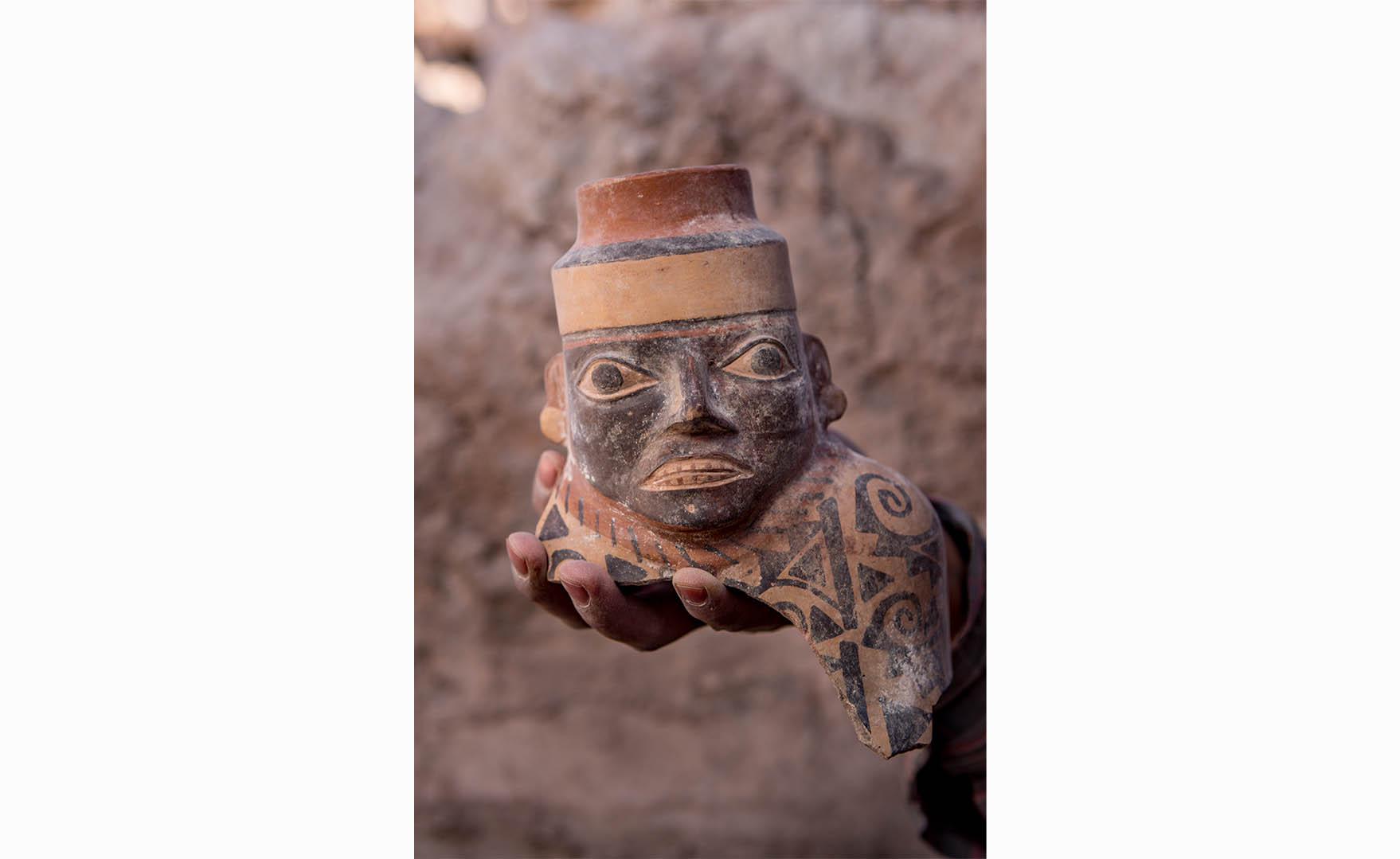 Close-up of a face-necked jar. More than 800 years before the Inca, the Wari State expanded out of the central Peruvian Sierra around 600 AD and shaped interactions in the region for the next four hundred years. Wari ceramics like this Robles Moqo face-necked jar excavated at Quilcapampa can be found across much of Peru.