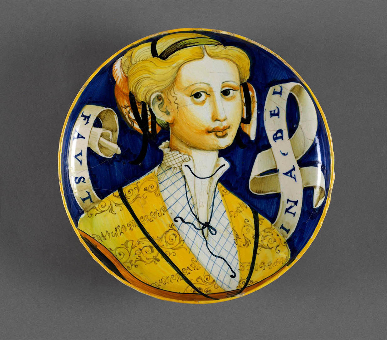 Assiette en poterie italienne avec une femme peinte dessus.
