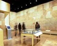 People look at the wall of the of the gallery which features a rebuilt painted Egyptian wall.