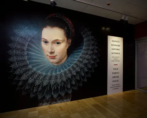 Mural of a woman with a lace ruff collar next to a vertical text panel listing names and dates.