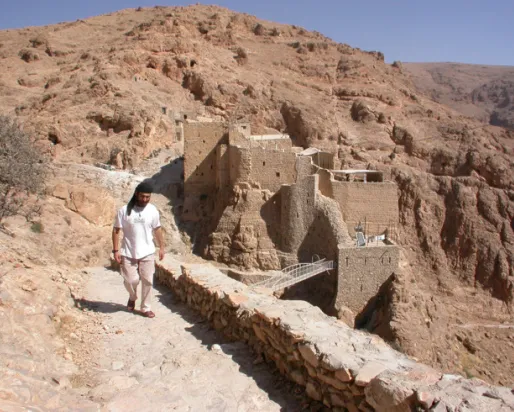 View of the old monastery buildings from the South in 2004, with then Brother Jihad, a member of the monastery.
