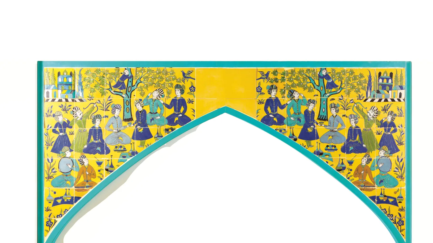 Colorful Islamic-style tile panel with geometric and floral patterns above an arch-shaped cutout.