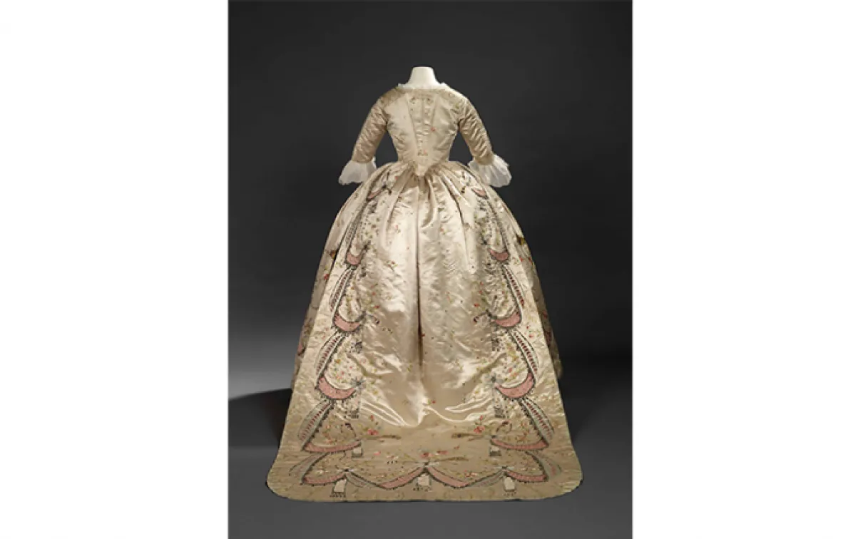 Overdress of a robe en fourreau. Attributed to Marie-Jean "Rose" Bertin (French couturière, 1747-1813). France. 1780's, altered in 1870's. Embroidered satin with ribbon appliqués, sequins, faceted glass stones mounted on silver facings, and silver filé; fitted, boned bodice. 925.18.3.A.