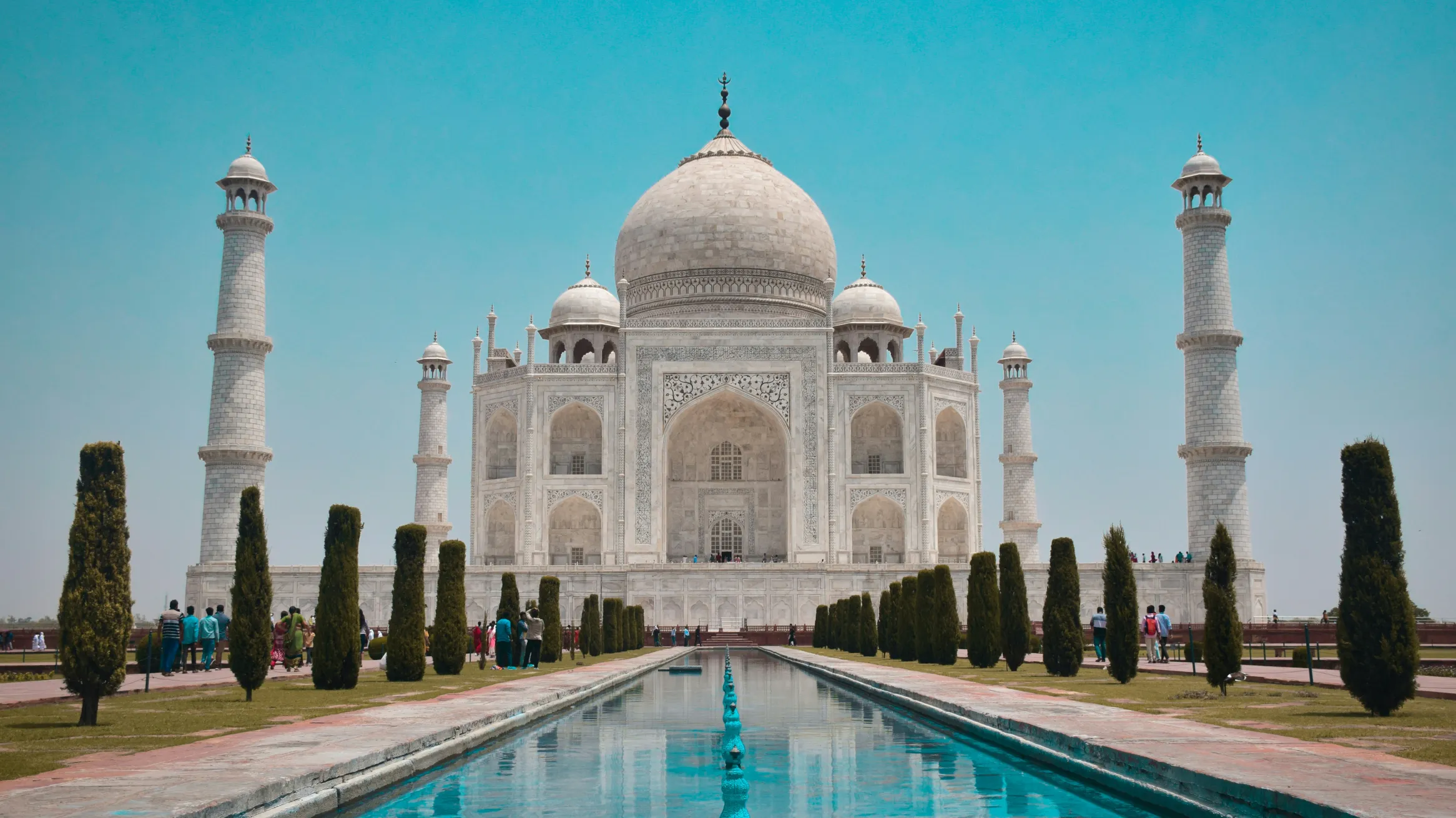 A white building with a dome and four towers